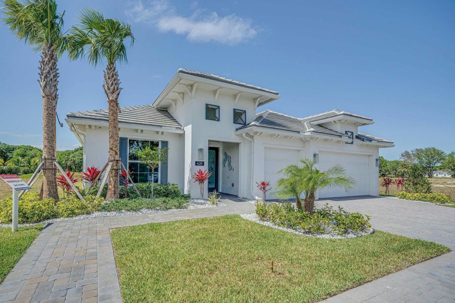 Front exterior of a new home in Lucaya Pointe, Vero Beach, FL, highlighting curb appeal (Image 1).