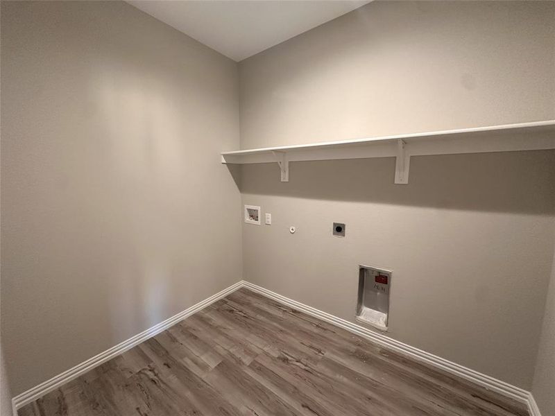 Washroom with hookup for a washing machine, hardwood / wood-style floors, gas dryer hookup, and electric dryer hookup