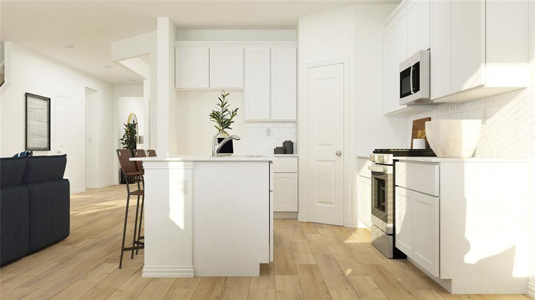 Kitchen featuring appliances with stainless steel finishes, light hardwood / wood-style flooring, and white cabinets