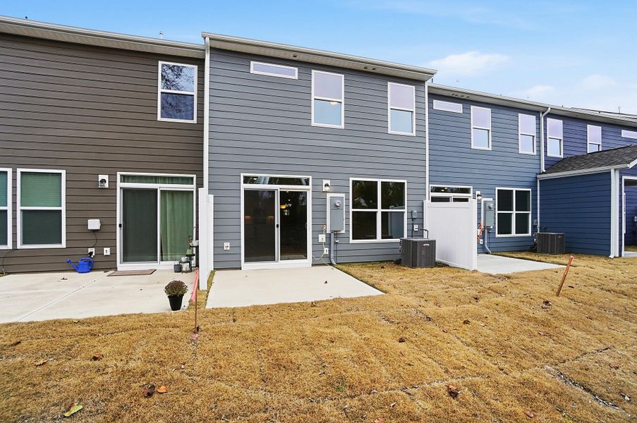Exterior details and patio area of a home in Harrisburg Village Townhomes, Harrisburg (Image 31).