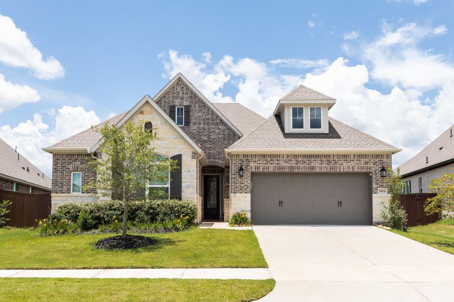 This listing boasts a gorgeous front with both brick and accent stone. It's definitely one to check out if you like a more traditional aesthetic.