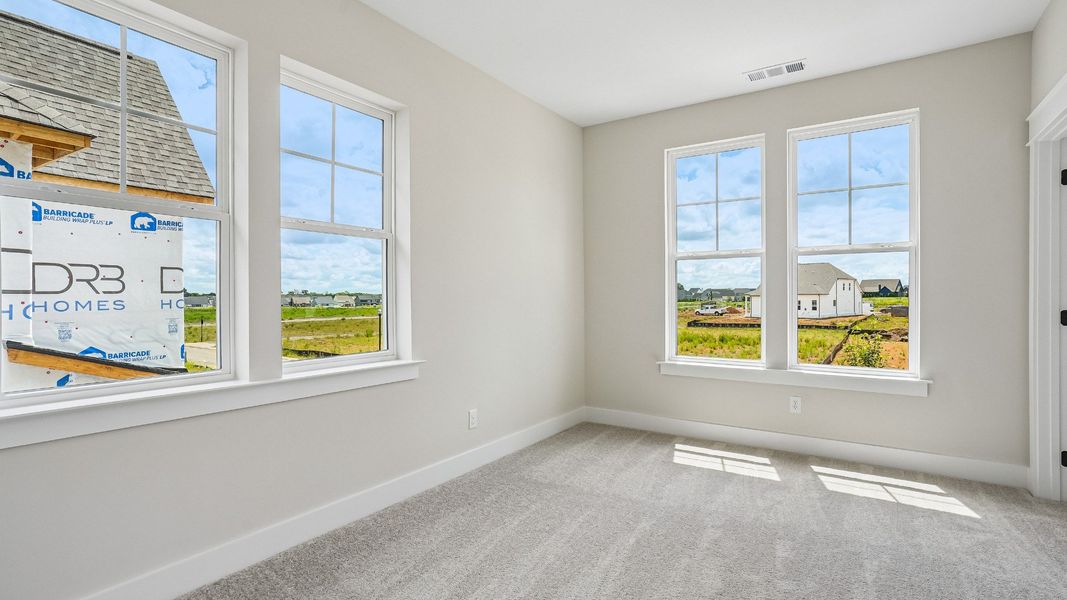 Guest Bedroom with surrounding windows