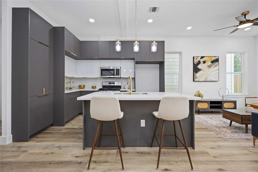 A beautiful modern kitchen with sleek and abundant cabinets provide lots of room for your cooking and entertaining needs.