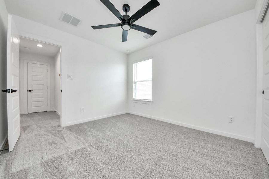 Generously sized secondary bedrooms featuring spacious closets, soft and inviting carpeting underfoot, large windows allowing plenty of natural light, and the added touch of privacy blinds for your personal retreat. Sample photo of completed home with similar floor plan. Actual colors and selections may vary. Generously sized secondary bedrooms featuring spacious closets, soft and inviting carpeting underfoot, large windows allowing plenty of natural light, and the added touch of privacy blinds for your personal retreat. Sample photo of completed home with similar floor plan. Actual colors and selections may vary.