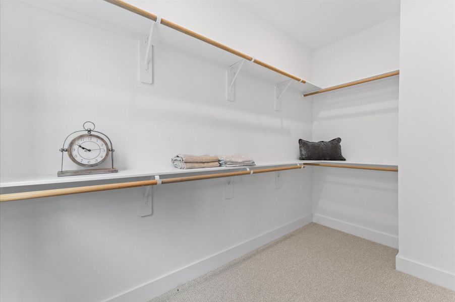 Step into this spacious walk-in closet, seamlessly connected to the primary bathroom. Step into this spacious walk-in closet, seamlessly connected to the primary bathroom.