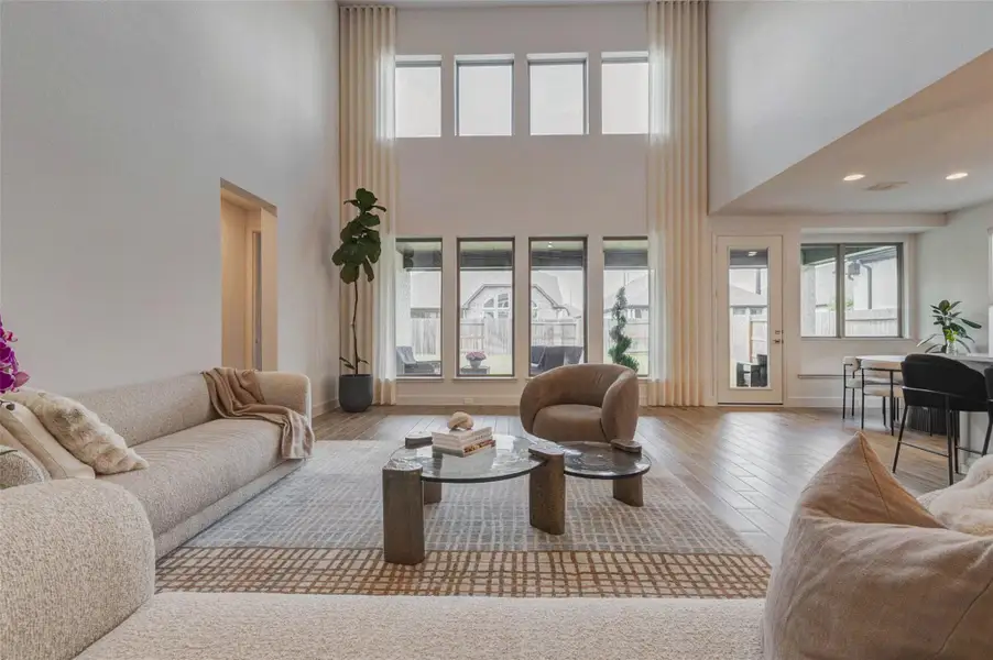 High ceilings, large windows for natural light, and elegant wood flooring. The open layout includes cozy seating, a neutral color palette, and modern decor, creating a comfortable and inviting atmosphere. High ceilings, large windows for natural light, and elegant wood flooring. The open layout includes cozy seating, a neutral color palette, and modern decor, creating a comfortable and inviting atmosphere.