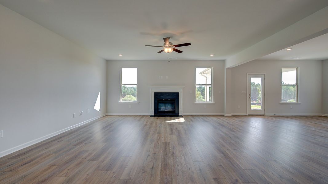 McKinley II bright open-concept family room with gas fireplace, natural light, and abundant seating area at Brighton.