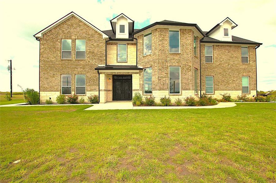 View of front of house with a front lawn and brick siding View of front of house with a front lawn and brick siding