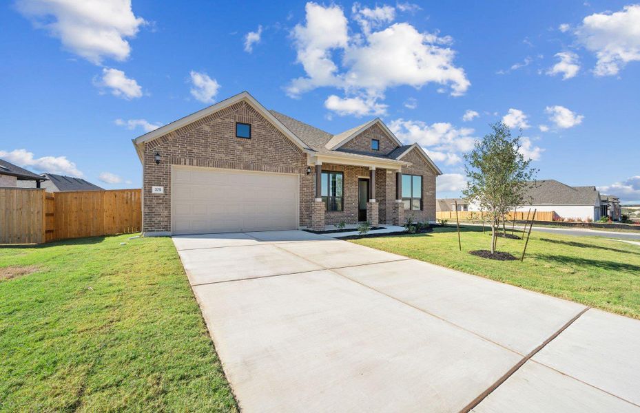 Front exterior of a new home in 6 Creeks, Kyle, TX, highlighting curb appeal (Image 2). Front exterior of a new home in 6 Creeks, Kyle, TX, highlighting curb appeal (Image 2).