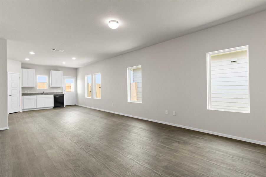 Unfurnished living room with dark wood-style floors and recessed lighting Unfurnished living room with dark wood-style floors and recessed lighting