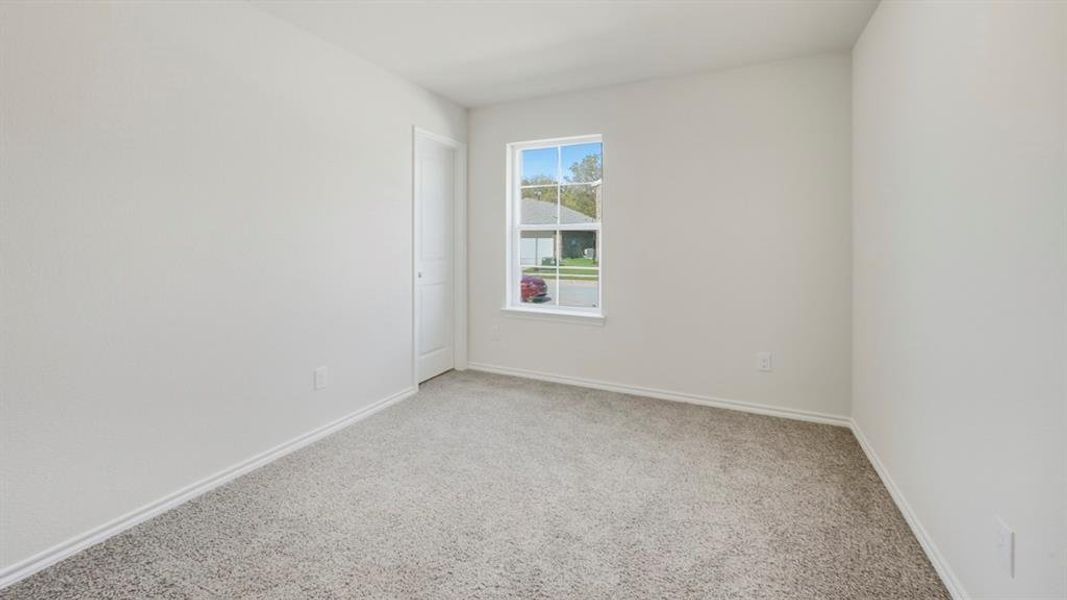 Unfurnished room featuring light colored carpet and baseboards