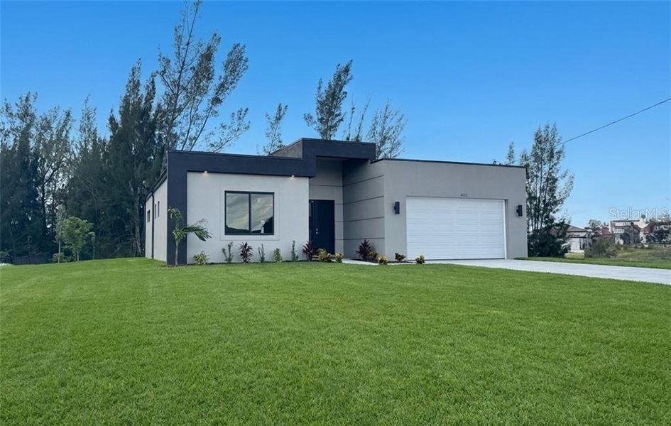 Front exterior of a new home in , Cape Coral, FL, highlighting curb appeal (Image 2). Front exterior of a new home in , Cape Coral, FL, highlighting curb appeal (Image 2).