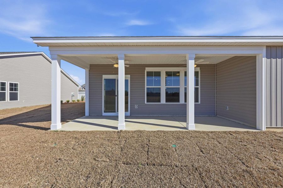 Back of property with ceiling fan and a porch