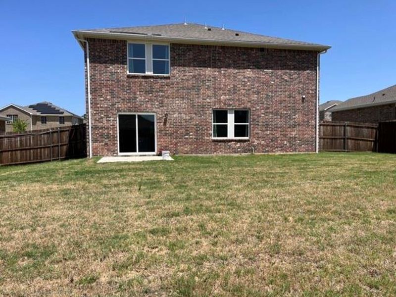 Rear view of property featuring a lawn