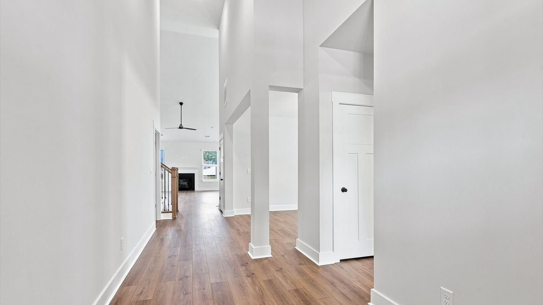 Memorable arrival experience with hardwood floors and elegant trim in the foyer Memorable arrival experience with hardwood floors and elegant trim in the foyer