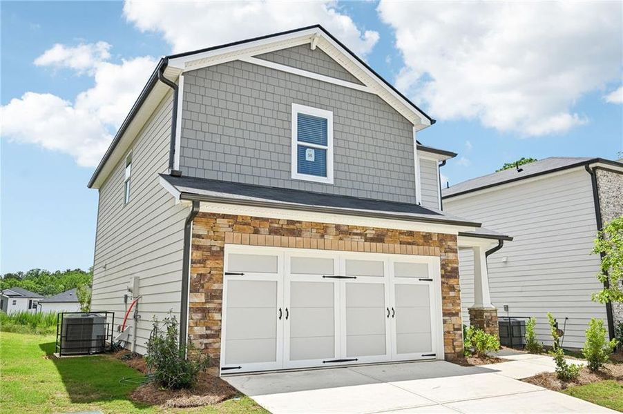 Front exterior of a new home in Hawthorne Station, College Park, GA, highlighting curb appeal (Image 23). Front exterior of a new home in Hawthorne Station, College Park, GA, highlighting curb appeal (Image 23).