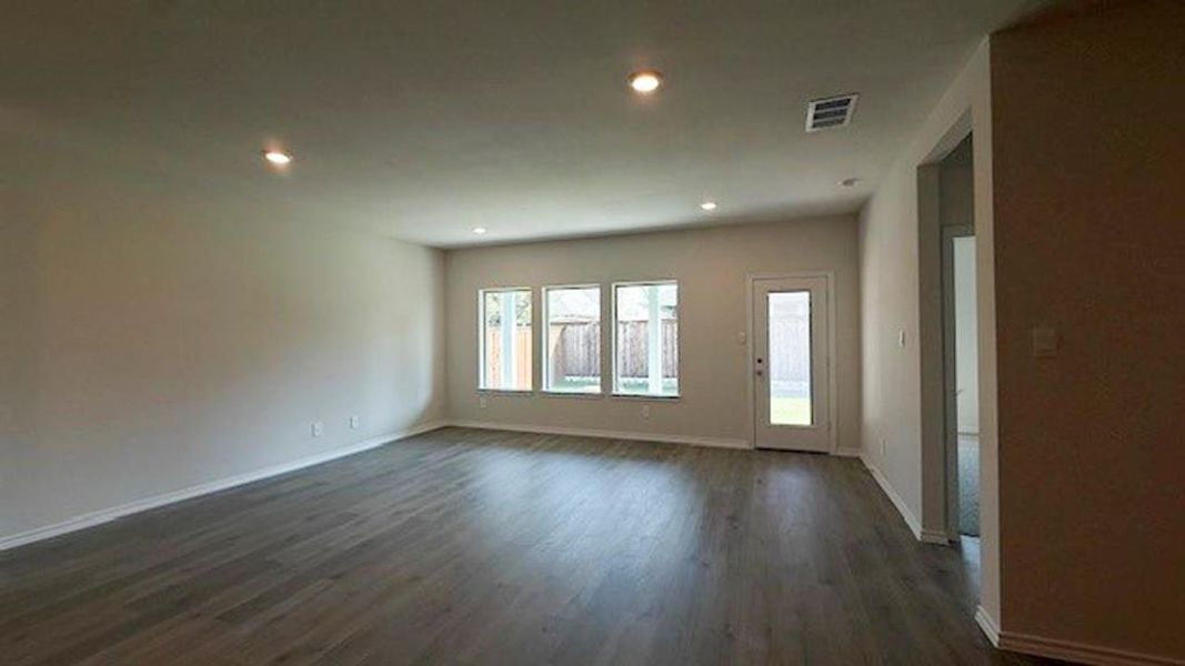 Unfurnished room with dark wood finished floors and recessed lighting