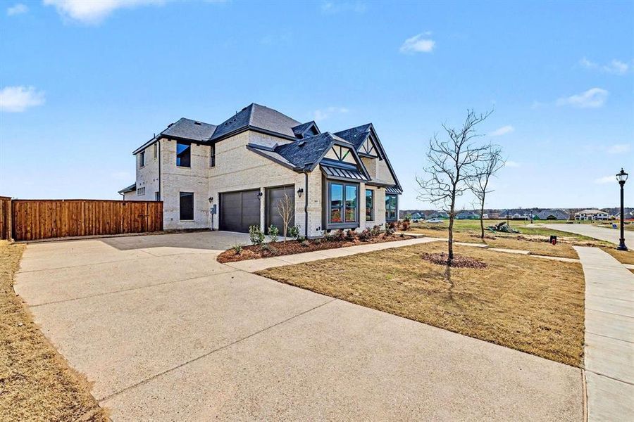 Front exterior of a new home in Malabar Hill, Prosper, TX, highlighting curb appeal (Image 21). Front exterior of a new home in Malabar Hill, Prosper, TX, highlighting curb appeal (Image 21).