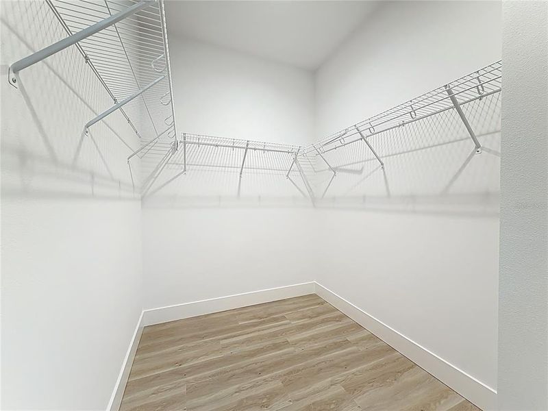 Primary suite walk-in closet. Primary suite walk-in closet.