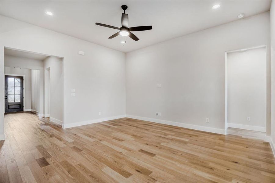 Empty room featuring a ceiling fan, recessed lighting, and light wood-style floors