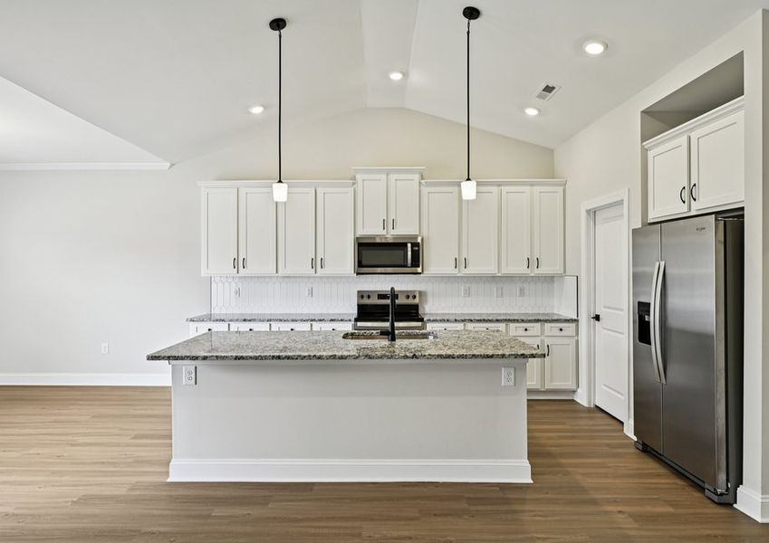 This kitchen features a sprawling island, giving plenty of space to prepare your family's favorite meals