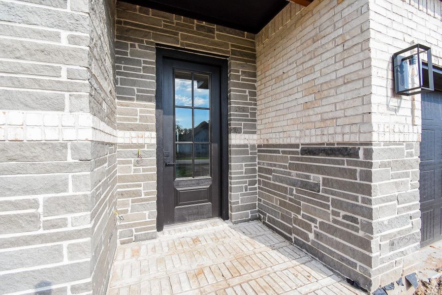 Stunning Entryway accented with attractive stone and brick design Stunning Entryway accented with attractive stone and brick design