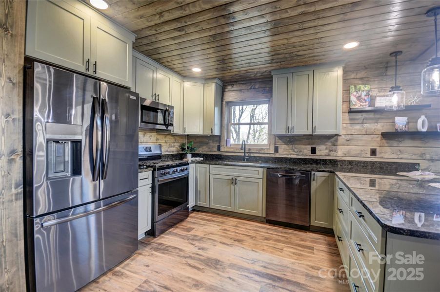 Beautiful smudge proof SS appliances with a gas stove featuring built-in air fryer and convection oven, dishwasher, microwave, and Refrigerator