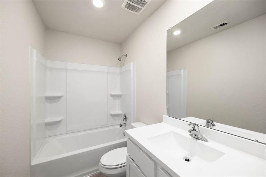 The secondary bathroom, located centrally in the hallway of the home.