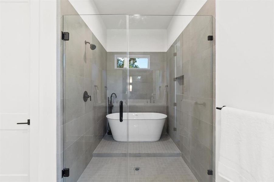 Primary bathroom containing a sleek wetroom.