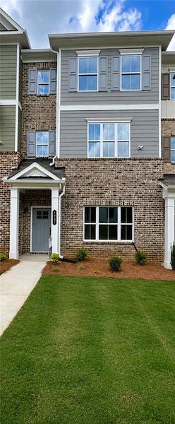 Front exterior of a new home in Townes at South Main, Kennesaw, GA, highlighting curb appeal (Image 2). Front exterior of a new home in Townes at South Main, Kennesaw, GA, highlighting curb appeal (Image 2).