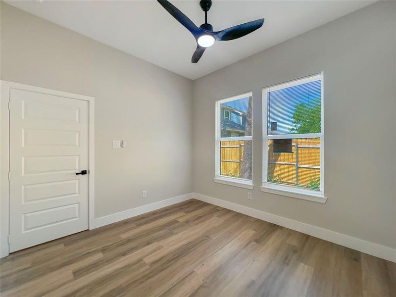 Spare room featuring baseboards, a ceiling fan, and light wood-style flooring Spare room featuring baseboards, a ceiling fan, and light wood-style flooring