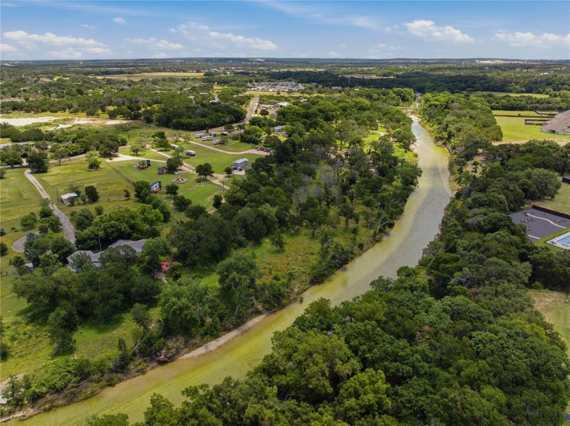 A winding river traverses verdant landscapes under a broad sky. A winding river traverses verdant landscapes under a broad sky.