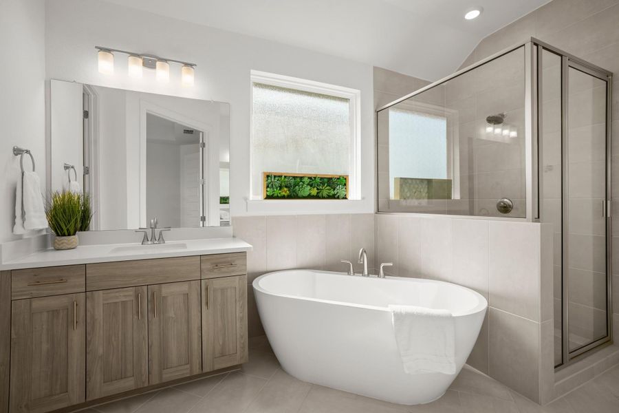 A well-appointed bath features a freestanding tub and a glass-enclosed shower.