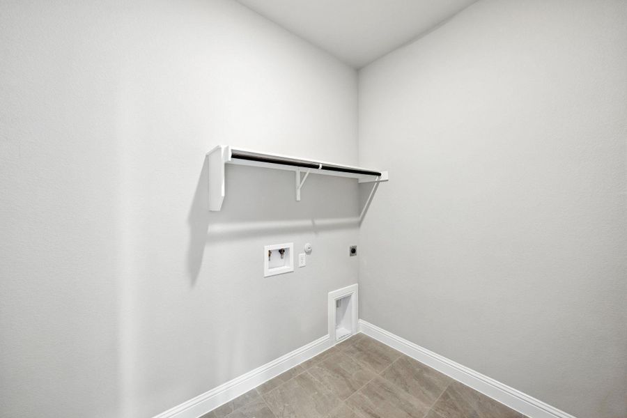 Laundry room featuring hookup for a gas dryer, electric dryer hookup, hookup for a washing machine, and light tile patterned flooring Laundry room featuring hookup for a gas dryer, electric dryer hookup, hookup for a washing machine, and light tile patterned flooring