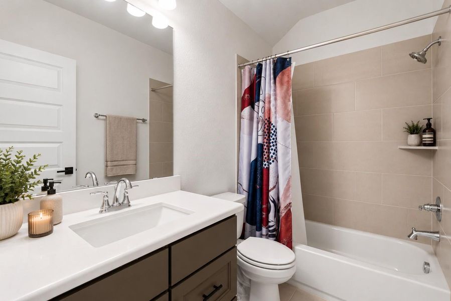 Another full bath featuring sleek/quartz vanity and refined finishes that elevate everyday living. Thoughtfully designed with a full tub/shower combo, this space offers both style and functionality for guests or family.
