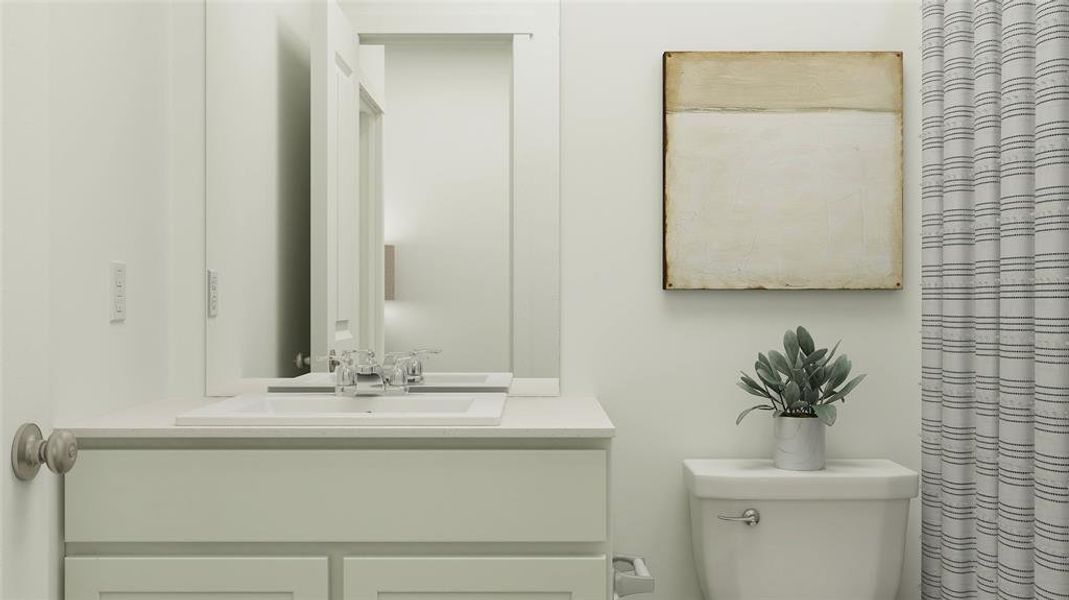 Bathroom featuring vanity and toilet