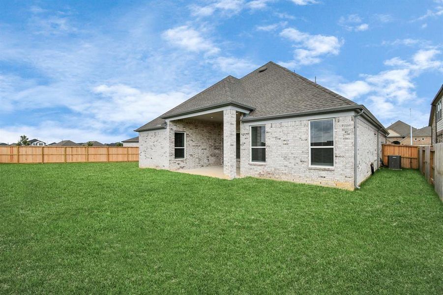 Experience outdoor living at its finest on this expansive covered patio, thoughtfully designed for BBQs and delightful outdoor dining.