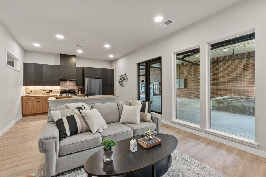 Living area featuring light wood finished floors and recessed lighting