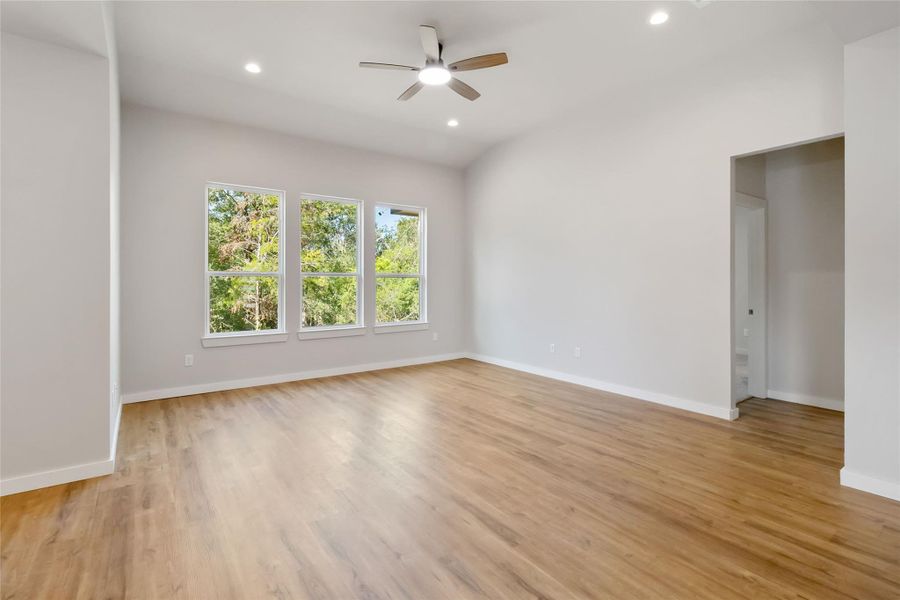 Spare room featuring a ceiling fan, light wood finished floors, recessed lighting, and lofted ceiling