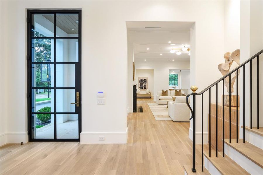 Foyer with light wood-style flooring, stairs, and recessed lighting Foyer with light wood-style flooring, stairs, and recessed lighting