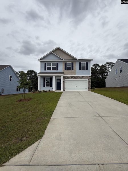 Front exterior of a new home in Cottages at Roofs Pond, West Columbia, SC, highlighting curb appeal (Image 27).
