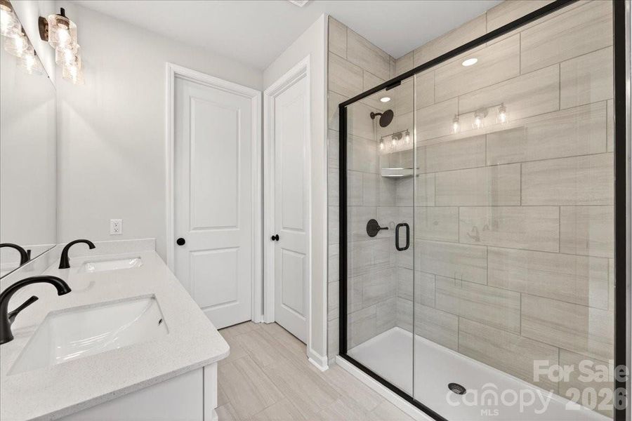 Dual vanity primary bathroom with walk-in shower Dual vanity primary bathroom with walk-in shower