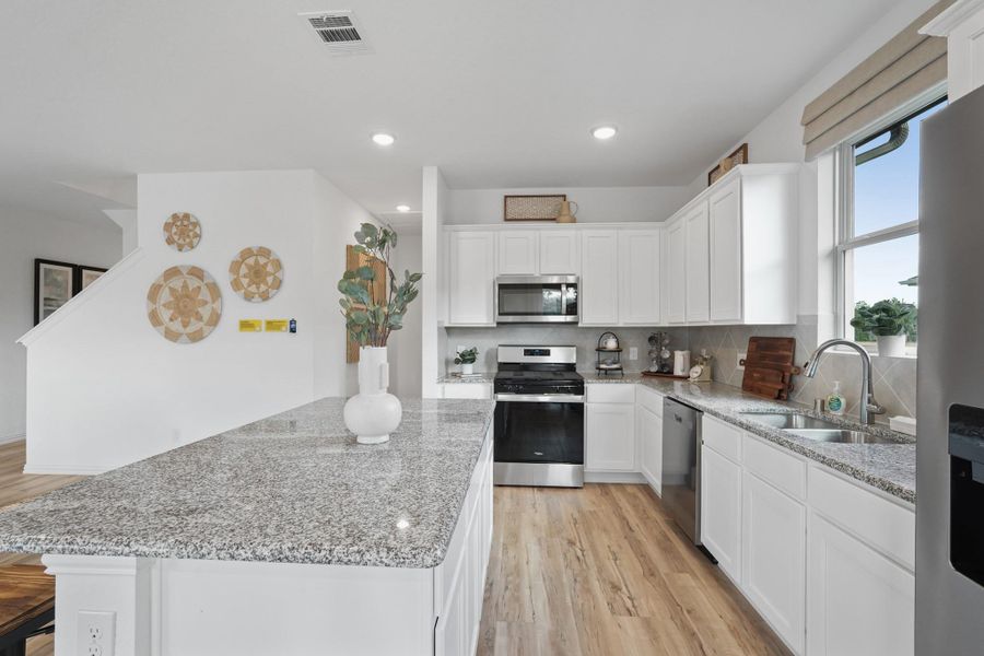 Durable countertops, stylish finishes, and thoughtful storage make this kitchen as practical as it is beautiful.