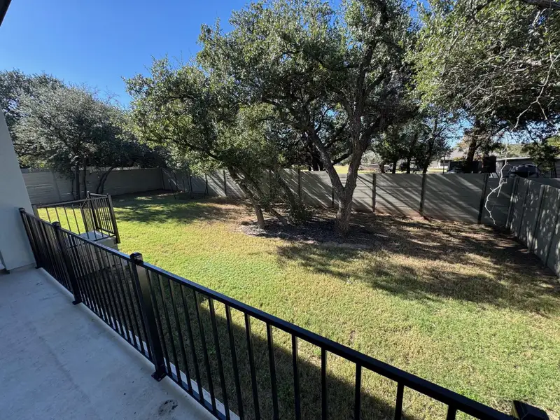 Fenced backyard featuring covers patio