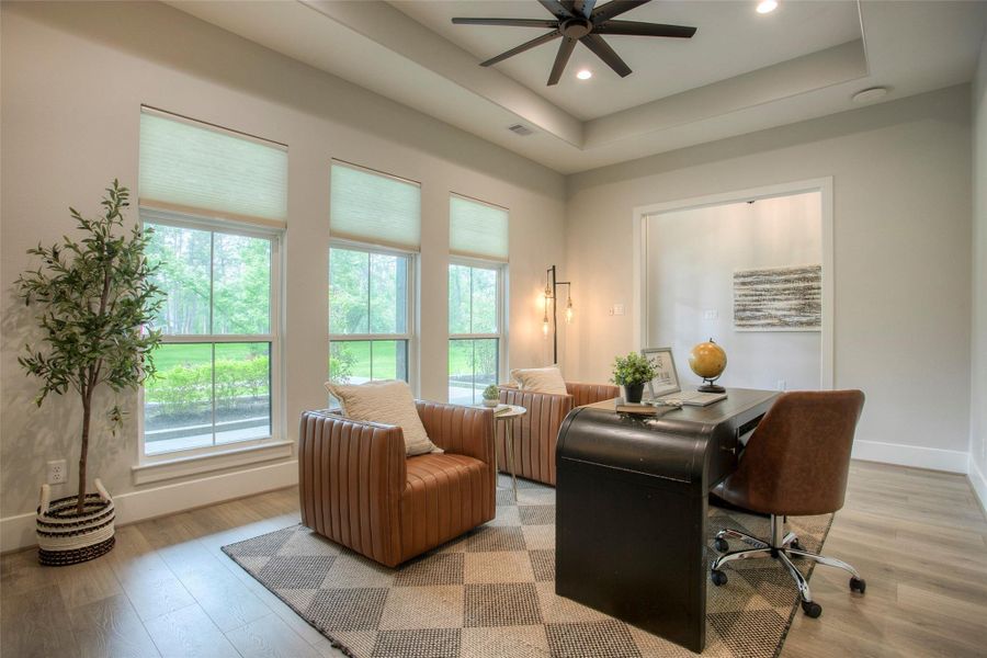 A bright and inviting home office with large windows to let all the natural light in.