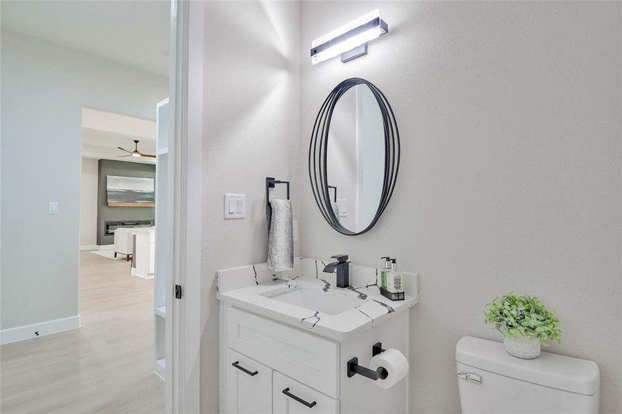 Bathroom featuring vanity and light wood-type flooring Bathroom featuring vanity and light wood-type flooring