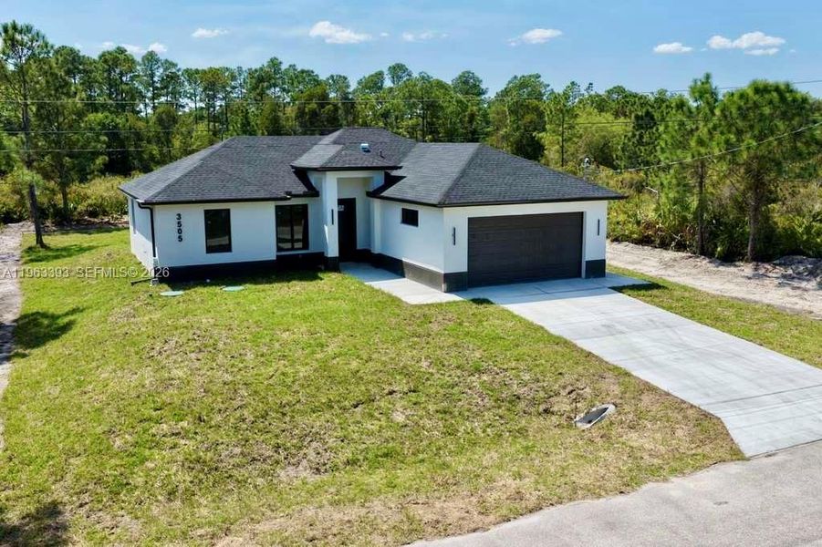 Front exterior of a new home in , Lehigh Acres, FL, highlighting curb appeal (Image 17).