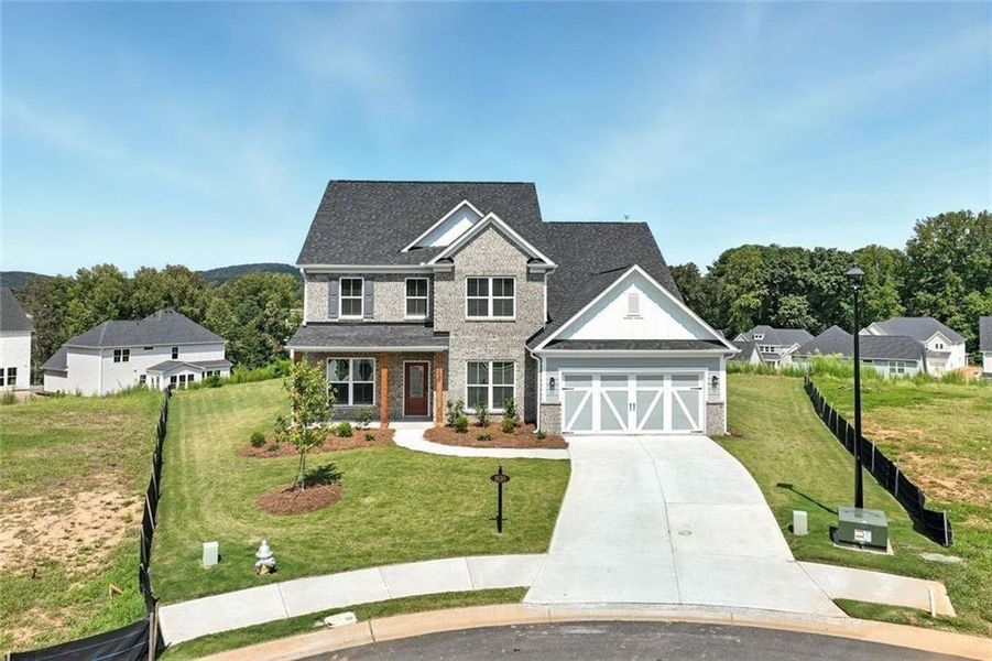 Front exterior of a new home in Berkeley Mill, Cumming, GA, highlighting curb appeal (Image 23). Front exterior of a new home in Berkeley Mill, Cumming, GA, highlighting curb appeal (Image 23).