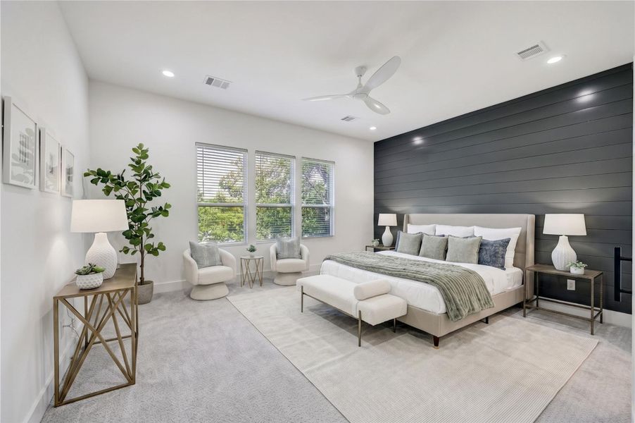 Primary Suite – A serene retreat featuring luxury carpeting and a statement wall.