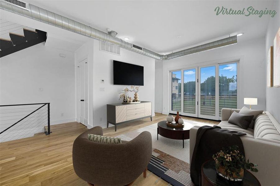 Living room with light wood finished floors and stairs
